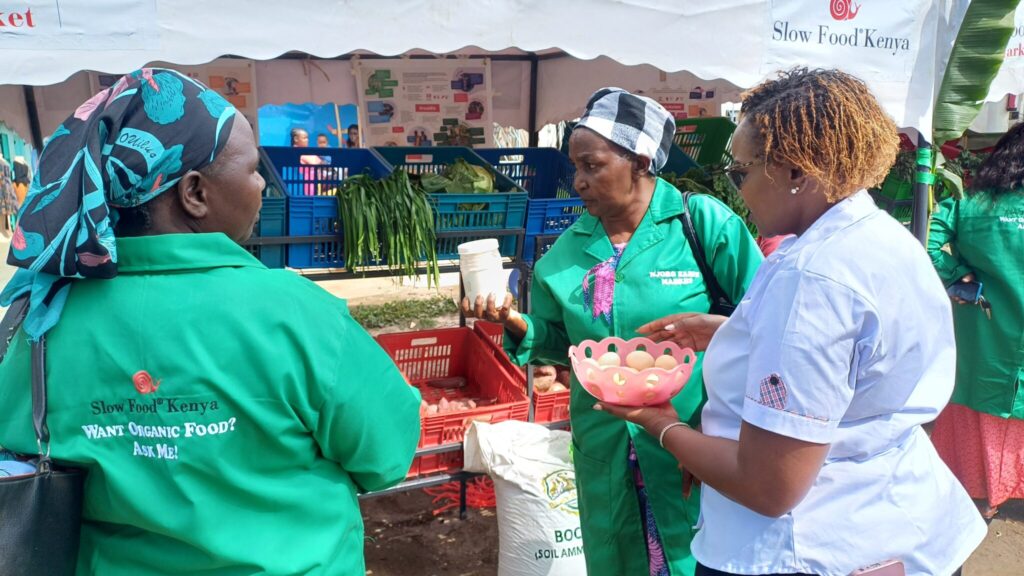 Kenyan women participating in the SLOW food movement in a Kenyan market